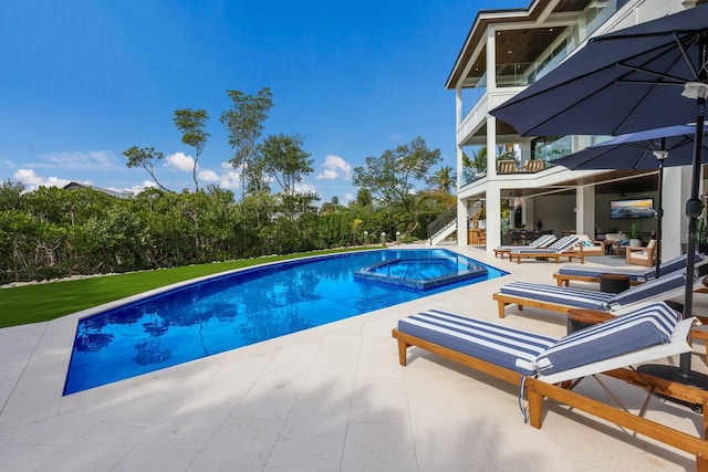 view of swimming pool featuring a patio area and an in ground hot tub