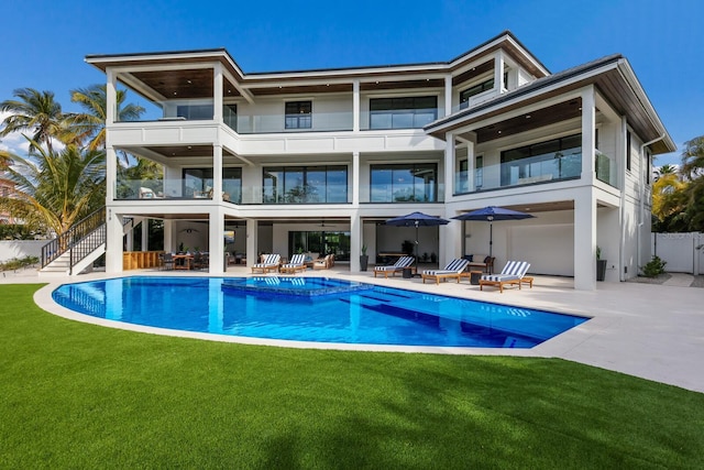 back of house featuring a lawn and a patio area