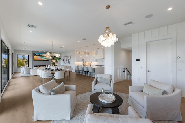 living room featuring hardwood / wood-style flooring and an inviting chandelier