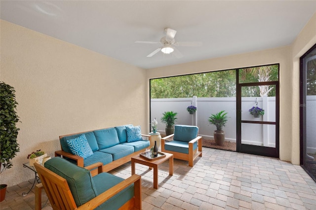 sunroom featuring ceiling fan