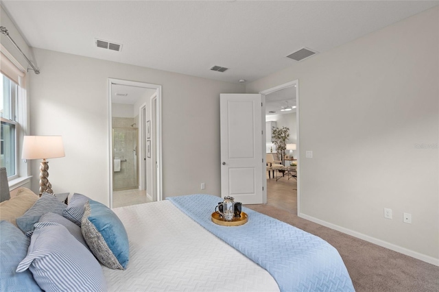 bedroom featuring light carpet and ensuite bath