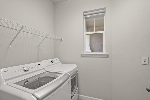 clothes washing area with washer and dryer