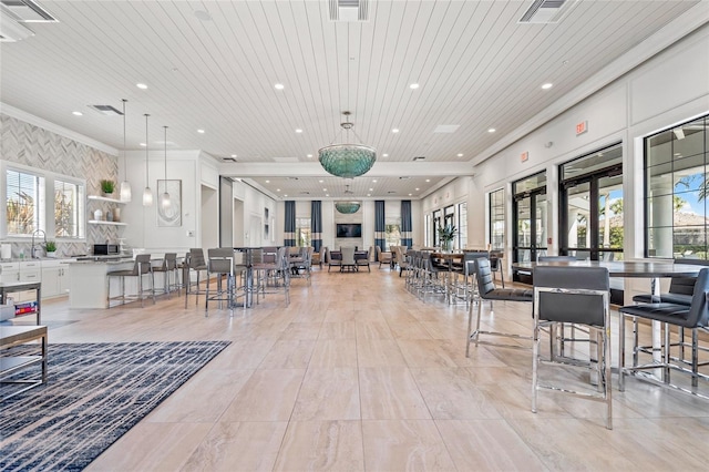 interior space featuring sink, crown molding, and wood ceiling