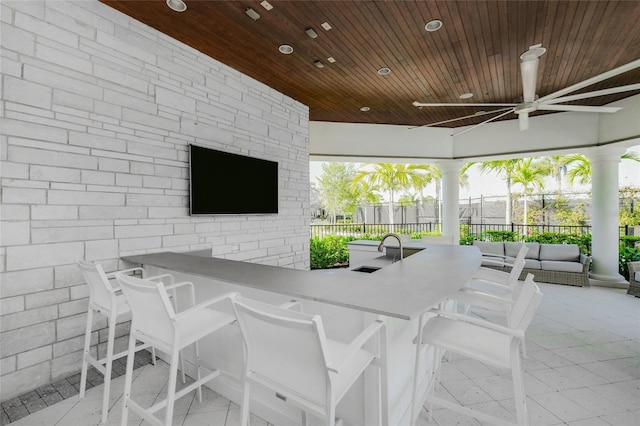 view of patio / terrace featuring a gazebo, ceiling fan, and an outdoor wet bar