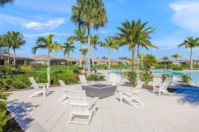 view of patio with a fire pit and a community pool