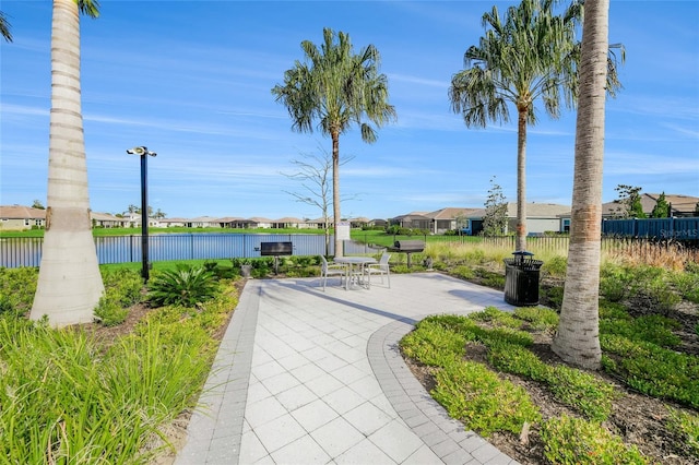 view of home's community with a water view and a patio