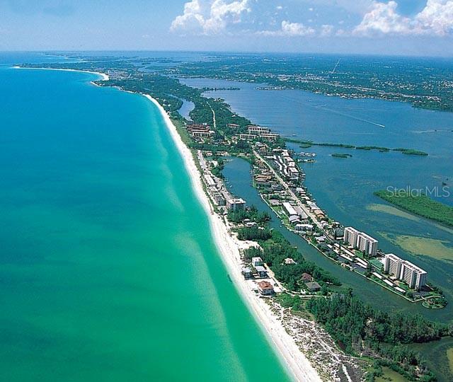 drone / aerial view with a water view and a beach view