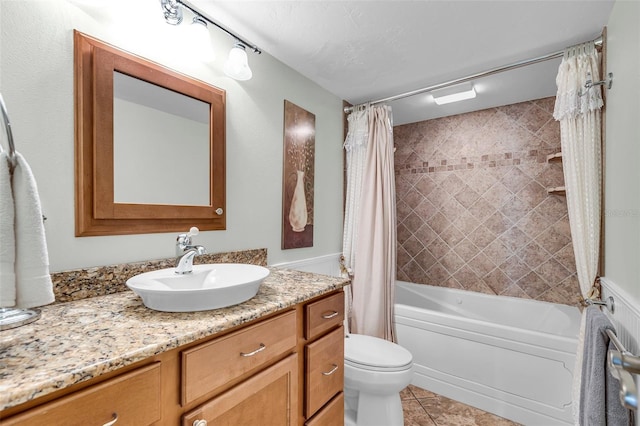 full bathroom featuring shower / bath combination with curtain, tile patterned floors, vanity, and toilet