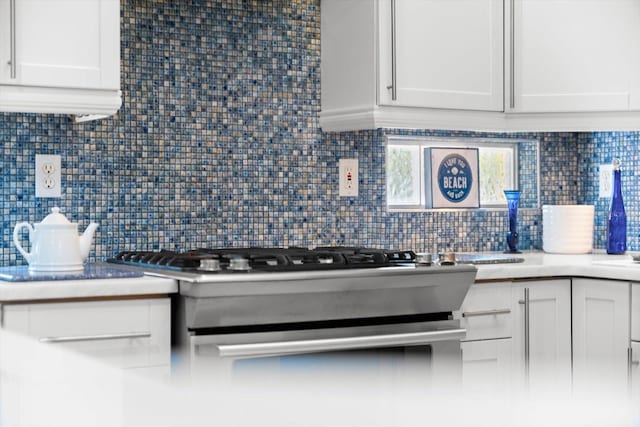 108 Corte Del Rosa, Venice, FL 34285 - kitchen with backsplash, white cabinets, and light countertops