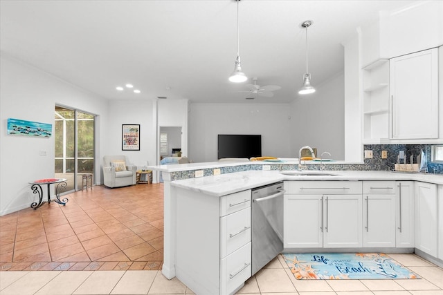 108 Corte Del Rosa, Venice, FL 34285 - kitchen with stainless steel dishwasher, open floor plan, open shelves, a peninsula, and white cabinetry