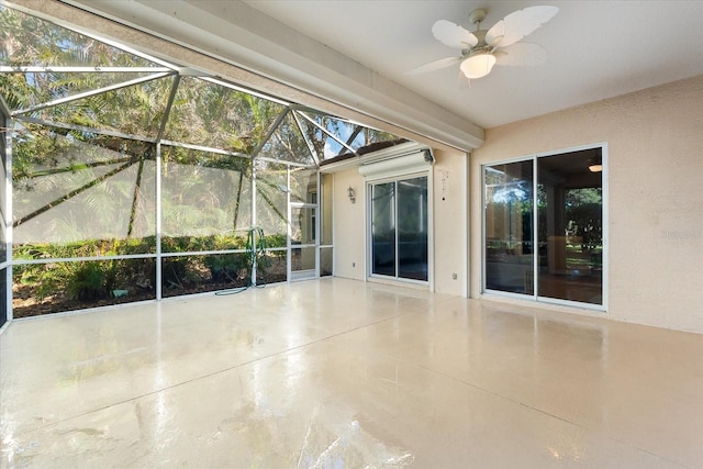 unfurnished sunroom featuring ceiling fan