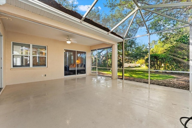 unfurnished sunroom featuring ceiling fan