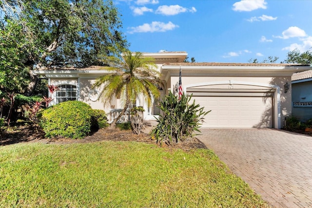 108 Corte Del Rosa, Venice, FL 34285 - view of front of property featuring driveway, a garage, stucco siding, and a front lawn