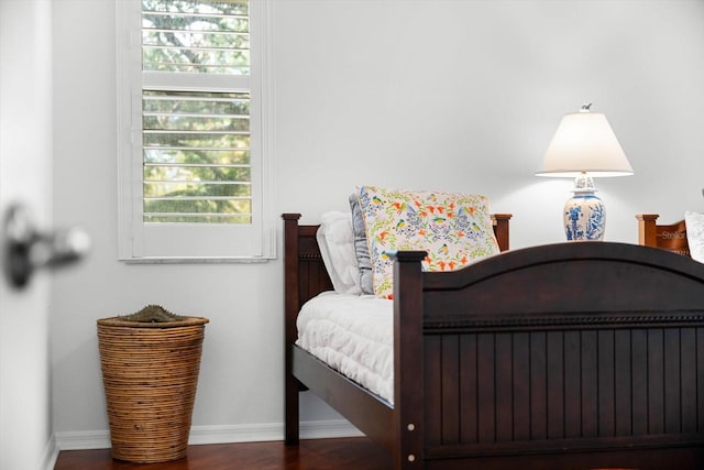 bedroom with dark wood-type flooring