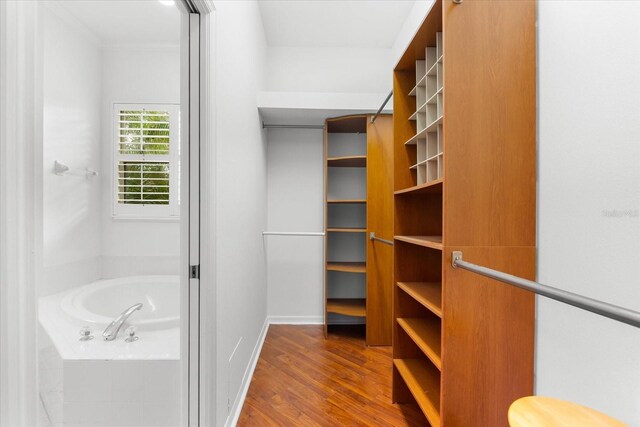 108 Corte Del Rosa, Venice, FL 34285 - walk in closet featuring wood finished floors