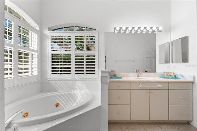 bathroom featuring tile patterned floors, vanity, and tiled tub