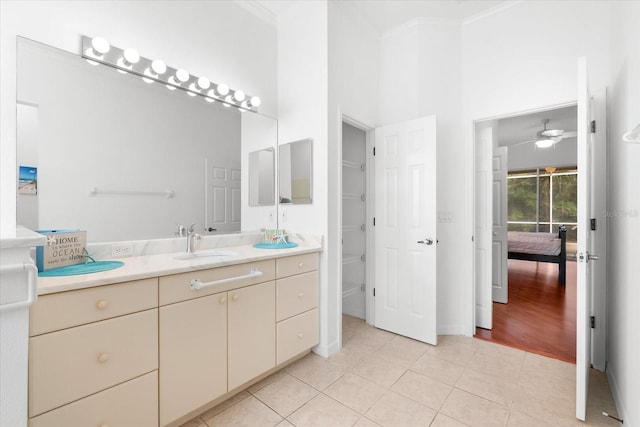 bathroom with tile patterned floors, ceiling fan, ornamental molding, and vanity