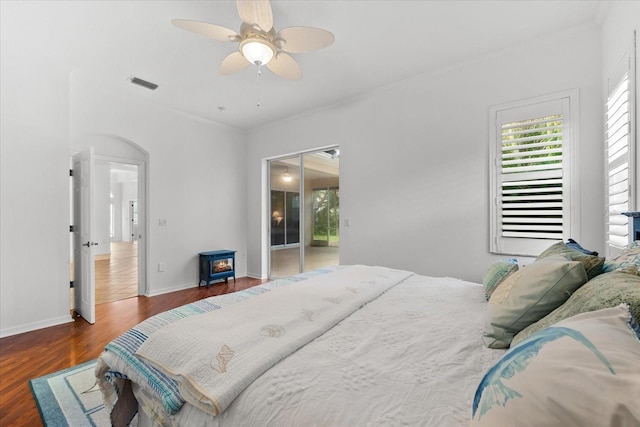 bedroom featuring ceiling fan, dark hardwood / wood-style floors, and access to exterior