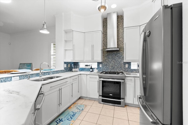 kitchen with wall chimney exhaust hood, stainless steel appliances, sink, white cabinets, and hanging light fixtures