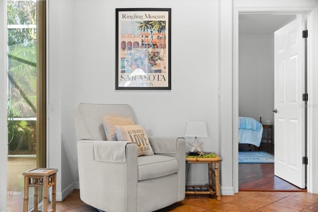 sitting room with tile patterned floors and plenty of natural light