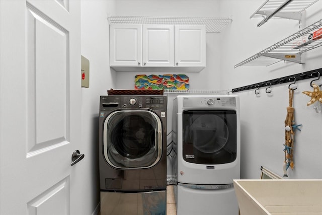 laundry area featuring cabinets and washing machine and clothes dryer