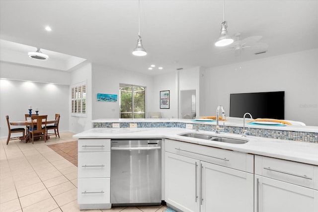 kitchen with pendant lighting, dishwasher, sink, ceiling fan, and white cabinetry