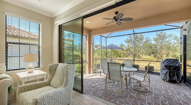 sunroom featuring plenty of natural light and ceiling fan