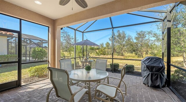 sunroom featuring ceiling fan