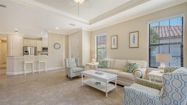 living room with crown molding, light tile patterned floors, a healthy amount of sunlight, and ceiling fan