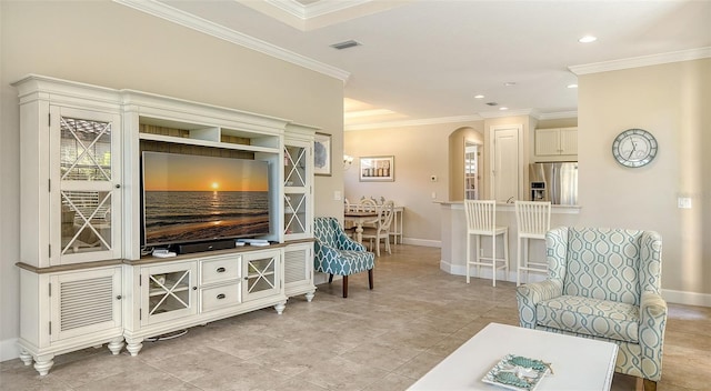 living room featuring light tile patterned floors and ornamental molding