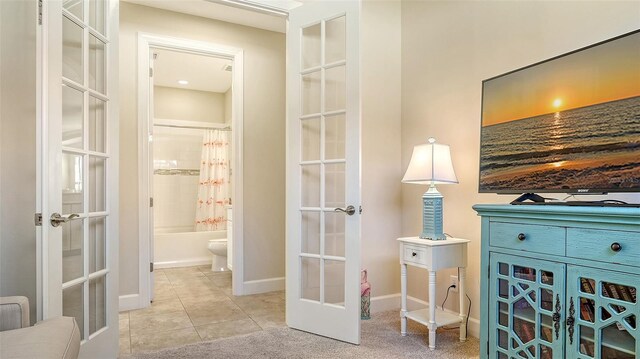 interior space with light tile patterned floors and french doors