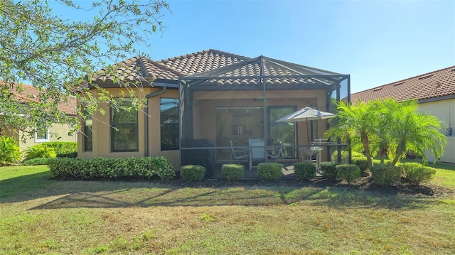 rear view of house featuring a lawn