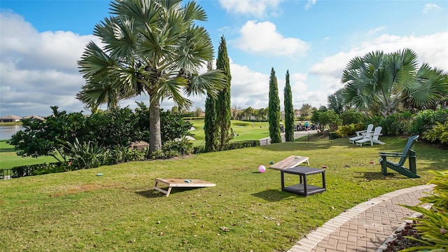 view of home's community featuring a yard and a water view