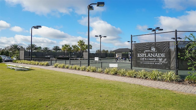 view of sport court featuring a lawn