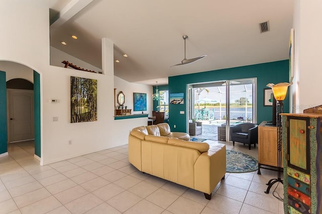 living room with light tile patterned floors and high vaulted ceiling