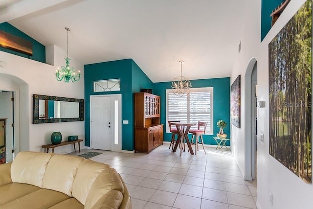 living room with light tile patterned floors, high vaulted ceiling, and a chandelier