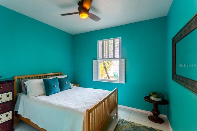 tiled bedroom with ceiling fan