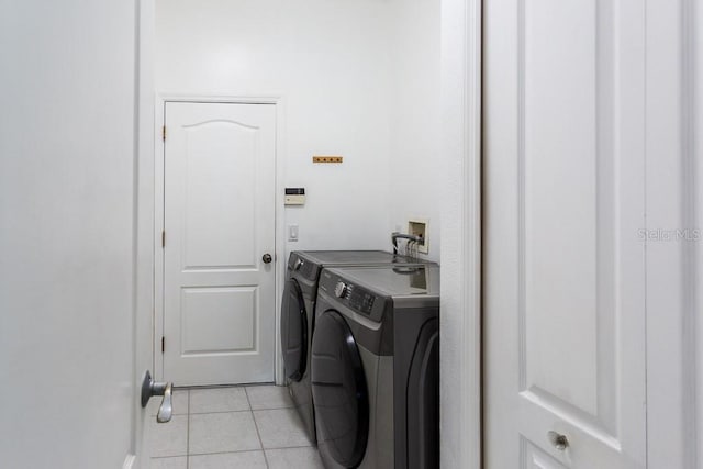 laundry room featuring light tile patterned floors and washer and dryer