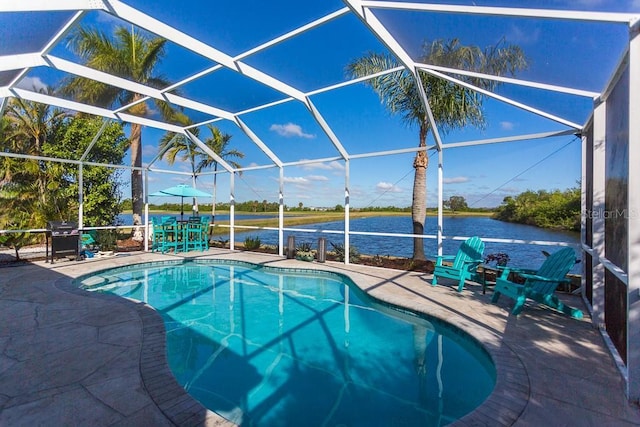 view of swimming pool featuring a lanai, a patio area, and a water view