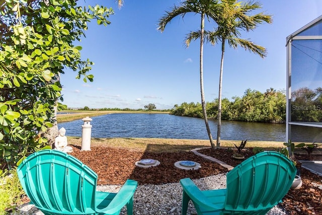 view of yard featuring a water view and glass enclosure