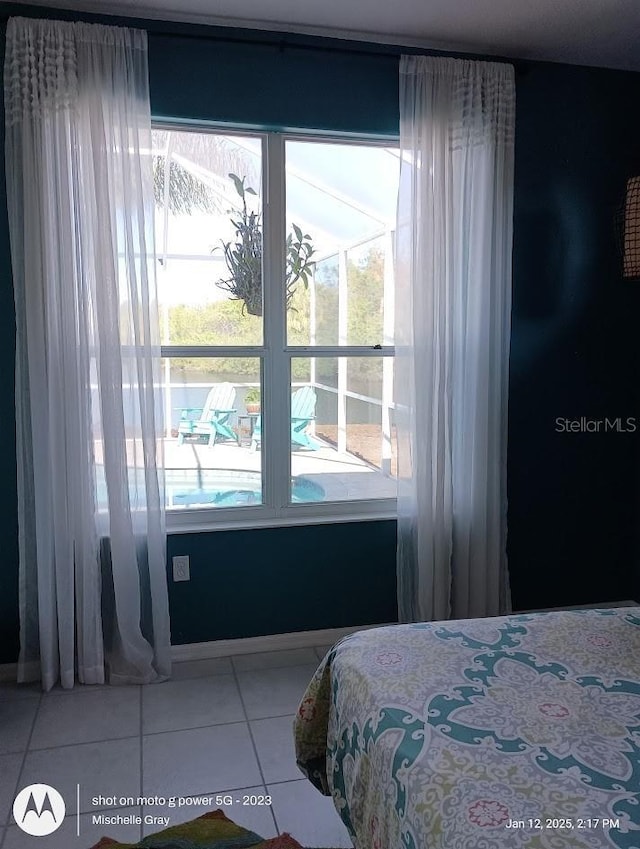 bedroom featuring tile patterned flooring and multiple windows