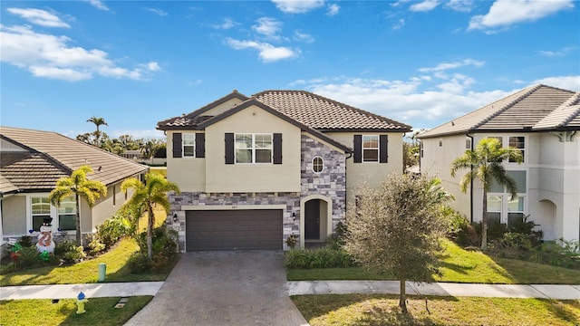 mediterranean / spanish home featuring a garage and a front lawn