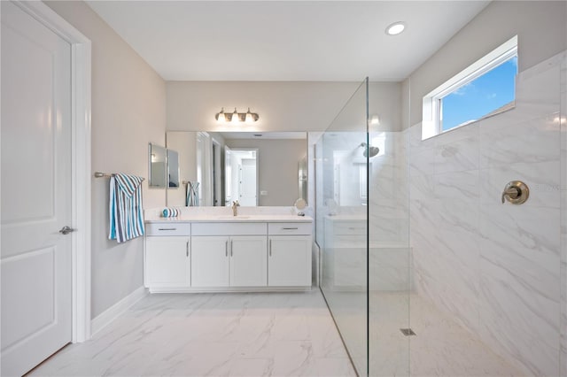 bathroom with vanity and tiled shower