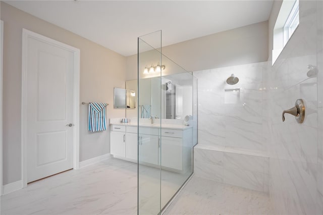 bathroom with vanity and tiled shower