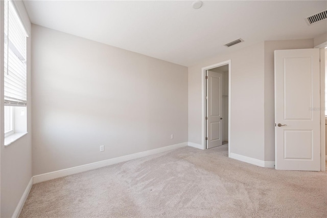 unfurnished bedroom with light carpet