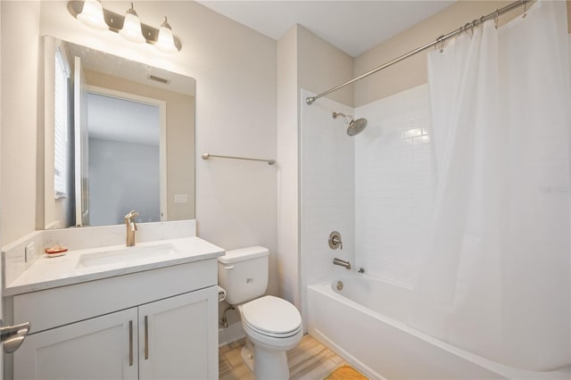 full bathroom with hardwood / wood-style flooring, vanity, shower / bath combination with curtain, and toilet