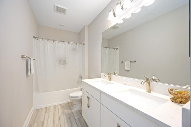 full bathroom featuring shower / tub combo, vanity, and toilet