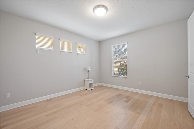 spare room with light hardwood / wood-style flooring