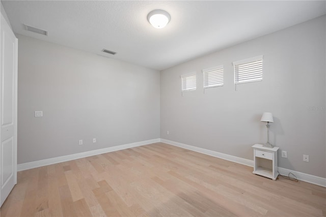 empty room with light hardwood / wood-style floors