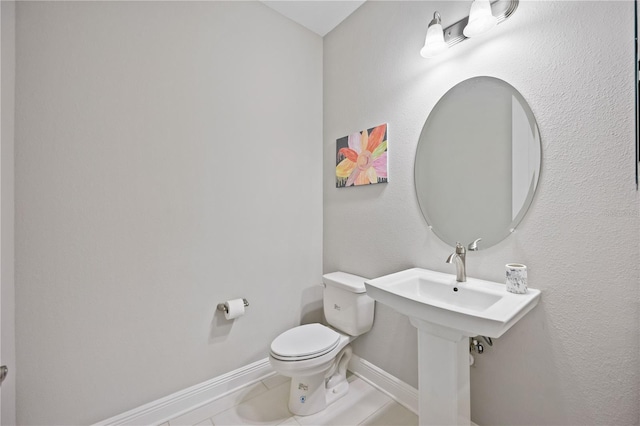 bathroom with tile patterned flooring and toilet